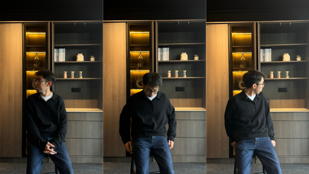 Nest Butler designer seated in front of bespoke display cabinetry with illuminated shelves at the Kota Damansara showroom.