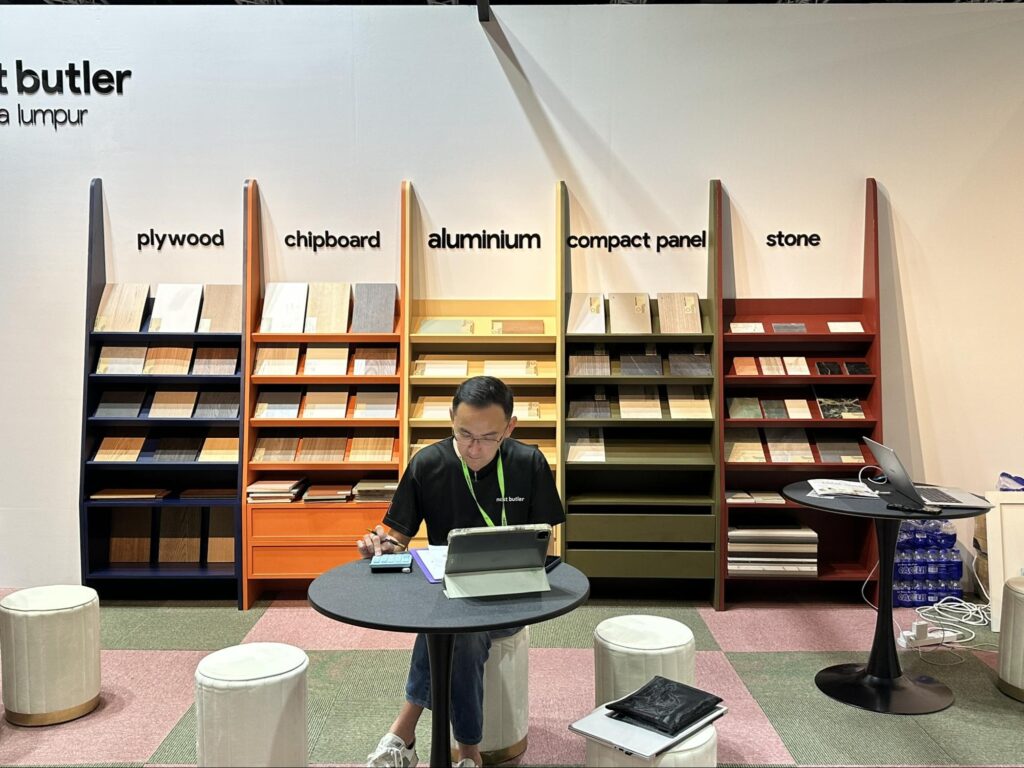Cabinet material display featuring plywood, chipboard, aluminium, compact panels, and stone samples at a Nest Butler HOMEDEC APR 2026. 